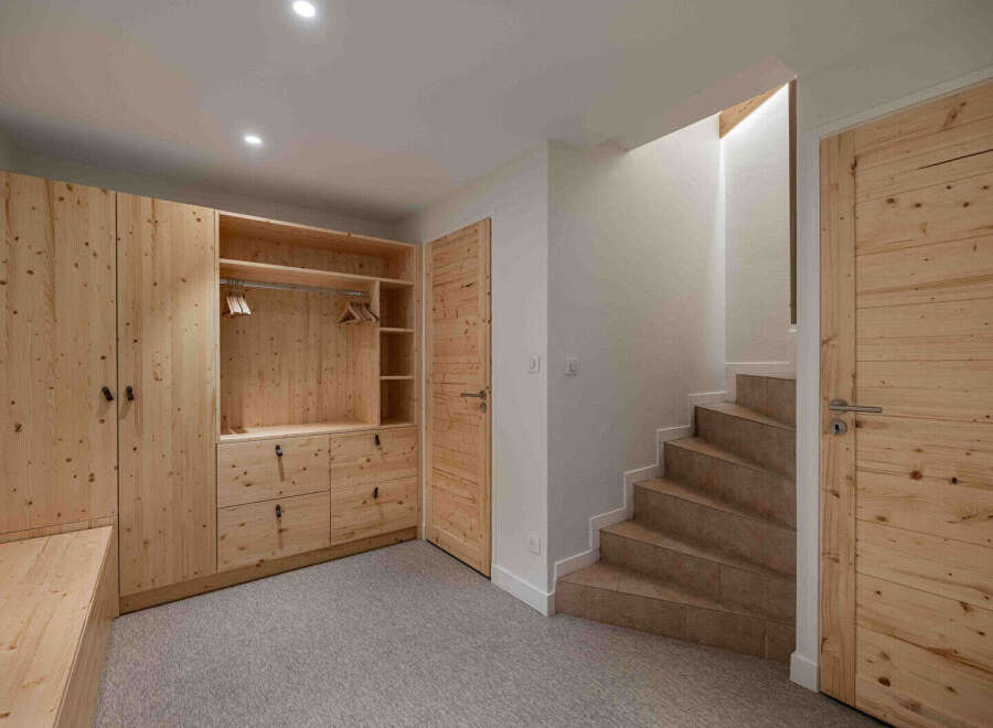 This stunning property boasts a beautifully crafted wooden wardrobe and a staircase leading to the upper levels.