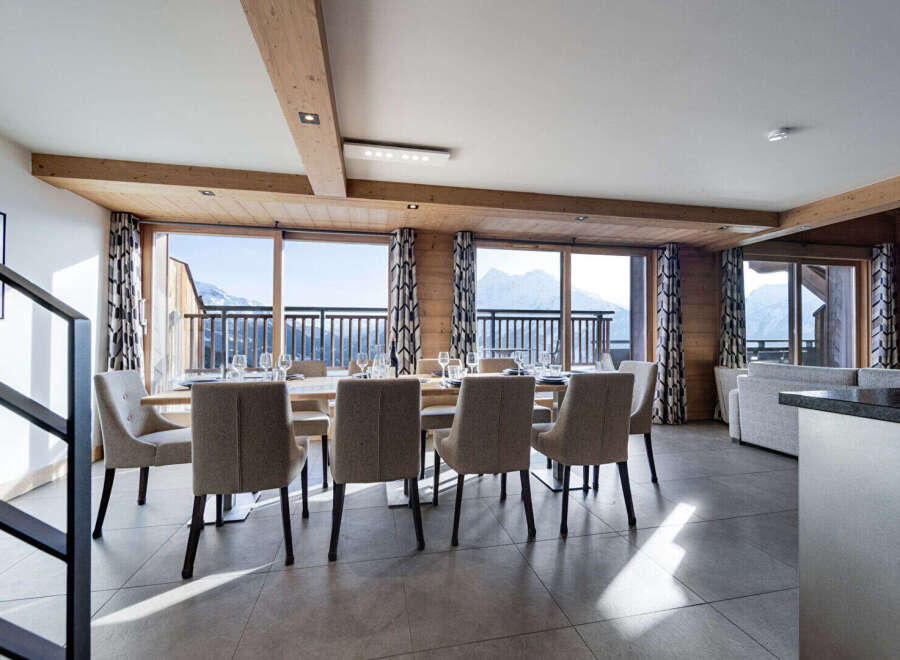 Experience luxury living in this stunning property, featuring a spacious dining area with breathtaking mountain views.