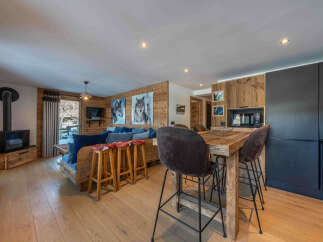 Experience the charm of this stunning property, featuring a cozy living area with a fireplace and a rustic wooden design.