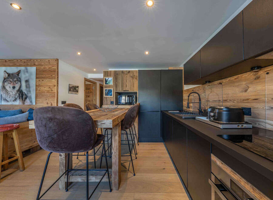 Experience the charm of this stunning kitchen, featuring a rustic wooden design and modern appliances.