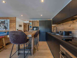 Experience the charm of this stunning kitchen, featuring a rustic wooden design and modern appliances.