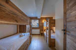 This cozy bedroom features custom-built bunk beds with wooden frames, perfect for accommodating multiple guests.