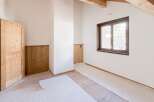 This charming room features a warm, inviting atmosphere with its natural wood door and trim.