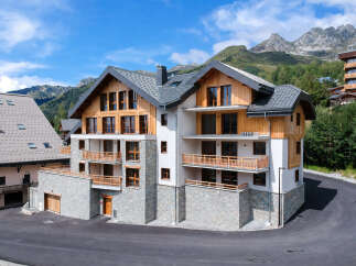 Discover this stunning mountain property featuring a modern chalet design with natural wood accents and stone facades.