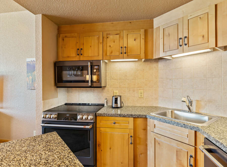 This charming kitchen boasts a modern design with sleek appliances and ample counter space.
