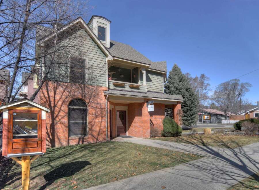 This charming property boasts a unique architectural design with a combination of brick and siding.