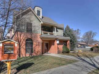 This charming property boasts a unique architectural design with a combination of brick and siding.