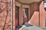 This charming brick building offers a welcoming entrance with two doors, perfect for a professional office space.