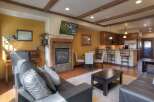 This stunning property boasts a cozy living room with a fireplace and a modern kitchen.