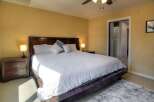 Step into this inviting bedroom, featuring a luxurious king-sized bed with a plush white comforter.