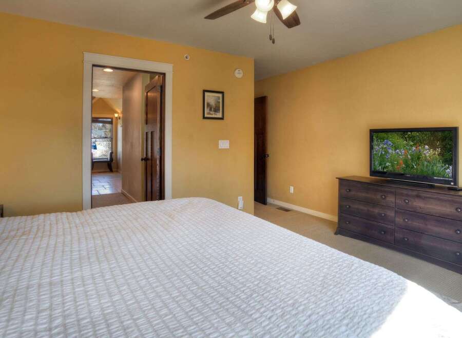 This inviting bedroom features a comfortable bed and a stylish dresser, perfect for relaxation.