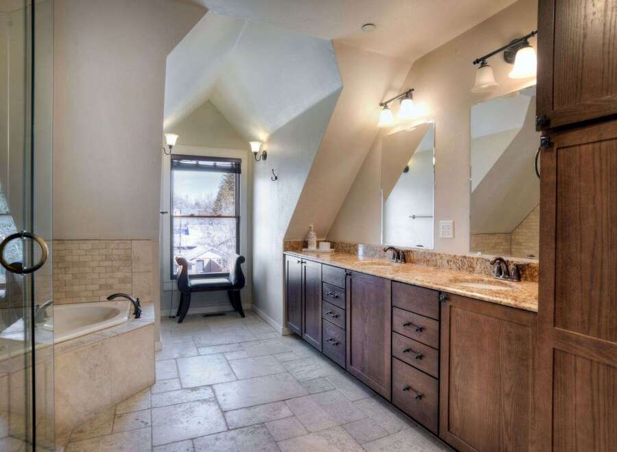 This luxurious bathroom boasts a spa-like ambiance with its elegant design and high-end finishes.