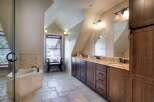 This luxurious bathroom boasts a spa-like ambiance with its elegant design and high-end finishes.