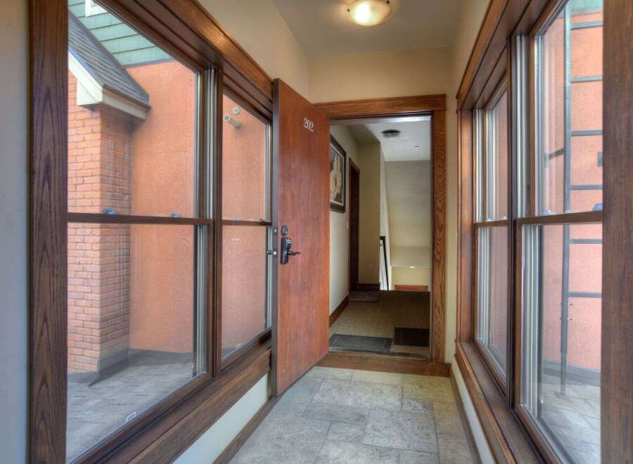 Step into this inviting entryway, showcasing beautiful wooden trim and abundant natural light.