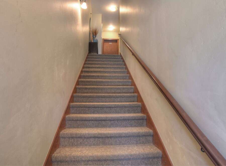 Ascend to your new home with these inviting stairs! This property features a well-maintained staircase, leading to a potential unit or common area.