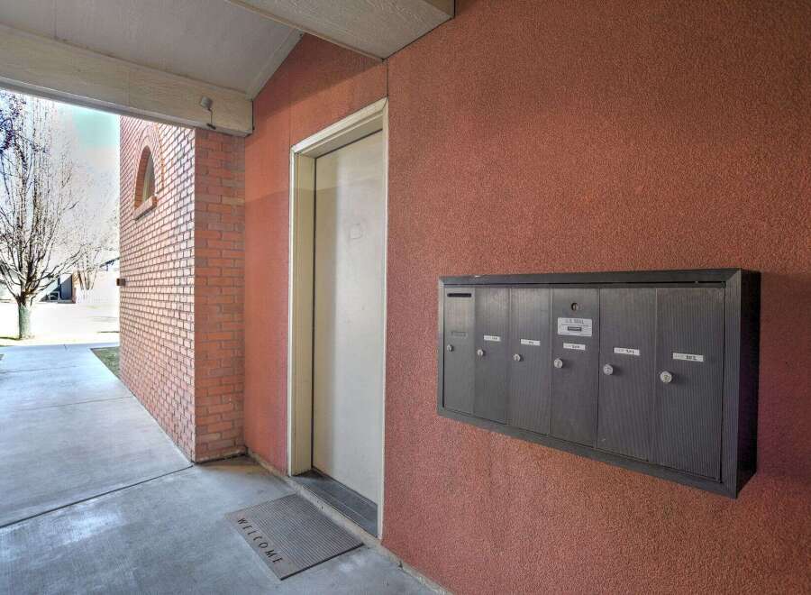 This property offers a welcoming entrance with a well-maintained walkway and a secure mailbox system.
