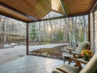 Enjoy the tranquility of nature from this charming porch.