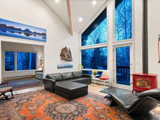 Experience the epitome of luxury living in this stunning property, boasting a spacious living area with soaring ceilings and expansive windows that frame breathtaking views.