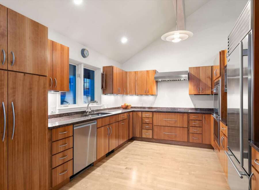 This stunning kitchen boasts custom cabinetry, offering ample storage and a sleek, modern aesthetic.