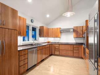 This stunning kitchen boasts custom cabinetry, offering ample storage and a sleek, modern aesthetic.