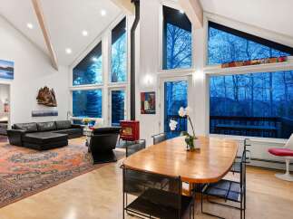 Experience luxury living in this stunning property featuring soaring ceilings and expansive windows that flood the space with natural light.