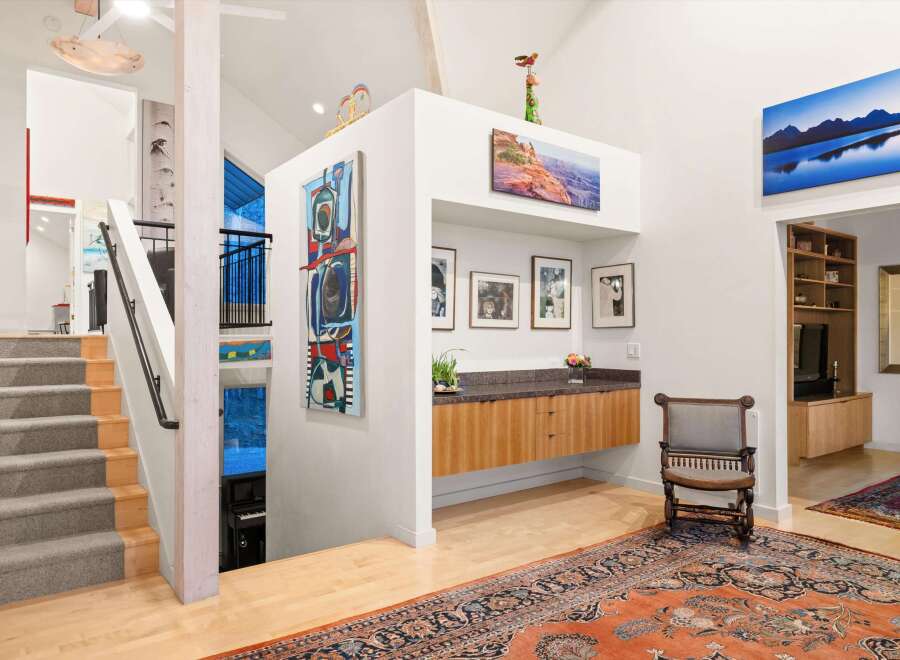 Step into luxury with this stunning property, showcasing a grand staircase and an open-concept design.