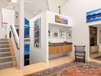 Step into luxury with this stunning property, showcasing a grand staircase and an open-concept design.