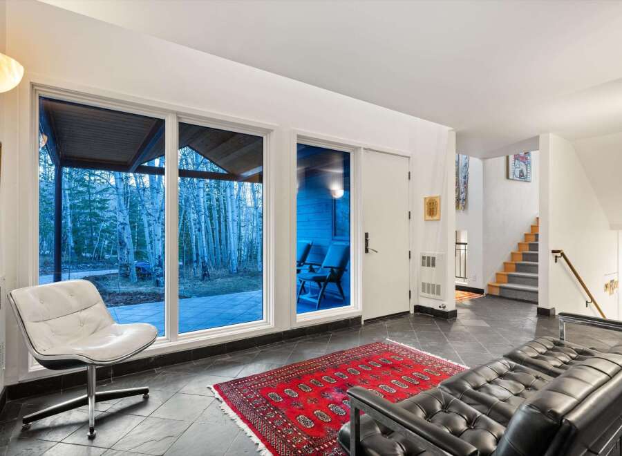 Step into modern elegance with this stunning property, featuring expansive windows that frame breathtaking views of the surrounding landscape.