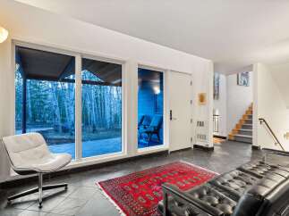 Step into modern elegance with this stunning property, featuring expansive windows that frame breathtaking views of the surrounding landscape.