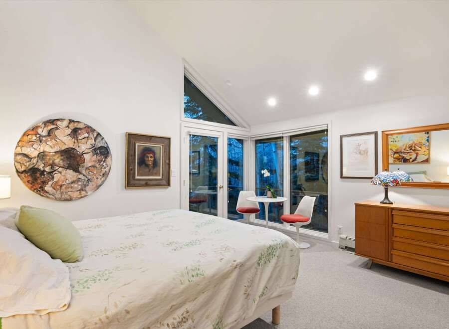 This stunning bedroom boasts a unique blend of art and natural light, creating a serene and inviting atmosphere.