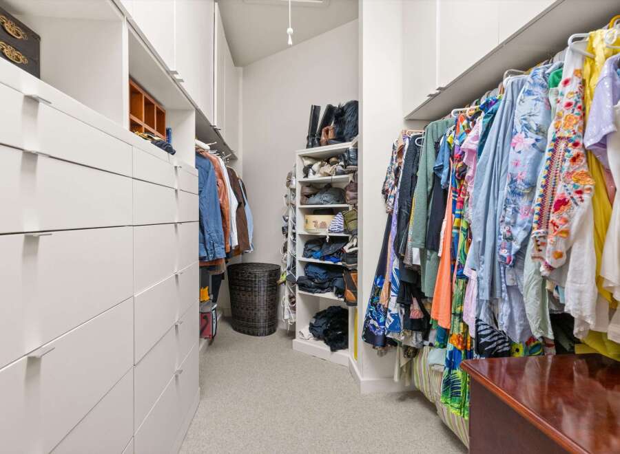 Step into luxury with this meticulously designed walk-in closet, offering ample storage and organization.