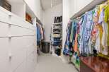 Step into luxury with this meticulously designed walk-in closet, offering ample storage and organization.