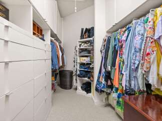 Step into luxury with this meticulously designed walk-in closet, offering ample storage and organization.