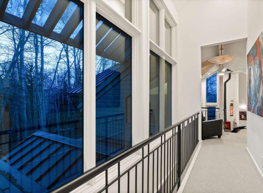 Experience the beauty of nature from this stunning property! This home features expansive windows that offer breathtaking views of the surrounding trees.