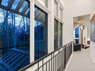 Experience the beauty of nature from this stunning property! This home features expansive windows that offer breathtaking views of the surrounding trees.
