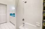 Step into this bright and inviting bathroom, featuring a pristine white tile design.
