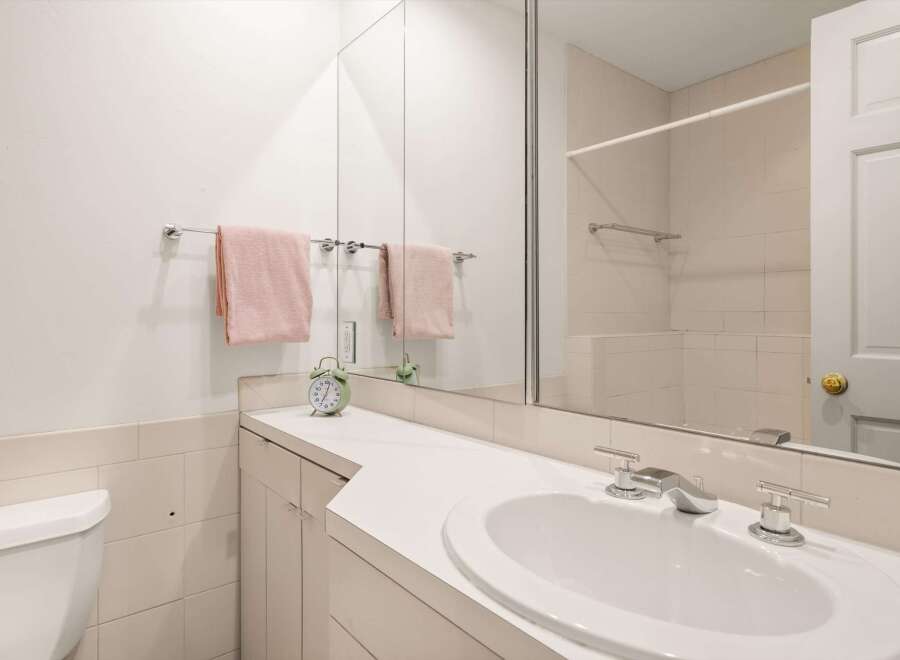 This bathroom features a clean and modern design with a bright, white aesthetic.