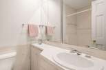 This bathroom features a clean and modern design with a bright, white aesthetic.