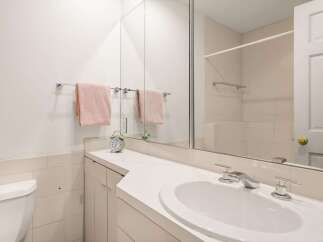This bathroom features a clean and modern design with a bright, white aesthetic.