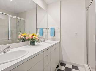 Step into a modern bathroom oasis! This stunning space features a sleek vanity with double sinks, perfect for your daily routines.