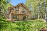Nestled amidst lush greenery and tall trees, this charming home offers a serene retreat.