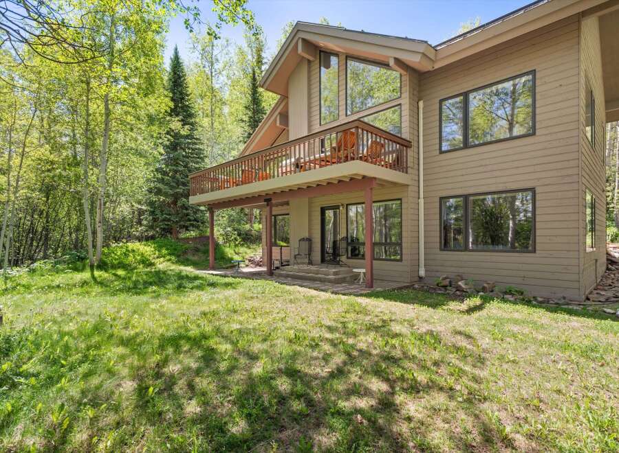 Nestled amidst lush greenery and mature trees, this charming home offers a serene retreat.