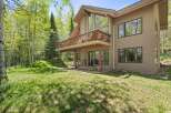 Nestled amidst lush greenery and mature trees, this charming home offers a serene retreat.
