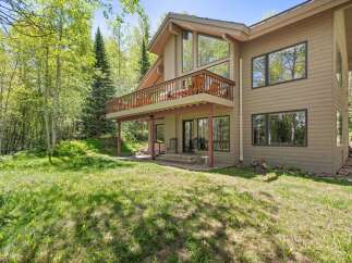 Nestled amidst lush greenery and mature trees, this charming home offers a serene retreat.