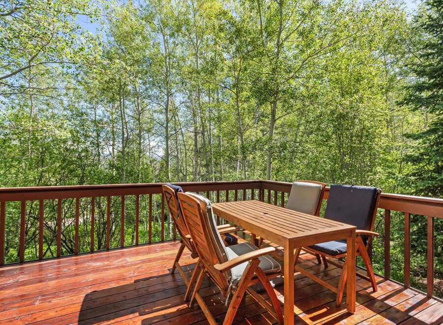 Enjoy the serene mountain views from this charming wooden deck, perfect for outdoor dining or morning coffee.