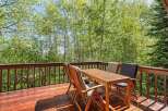 Enjoy the serene mountain views from this charming wooden deck, perfect for outdoor dining or morning coffee.