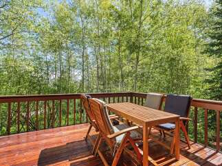 Enjoy the serene mountain views from this charming wooden deck, perfect for outdoor dining or morning coffee.