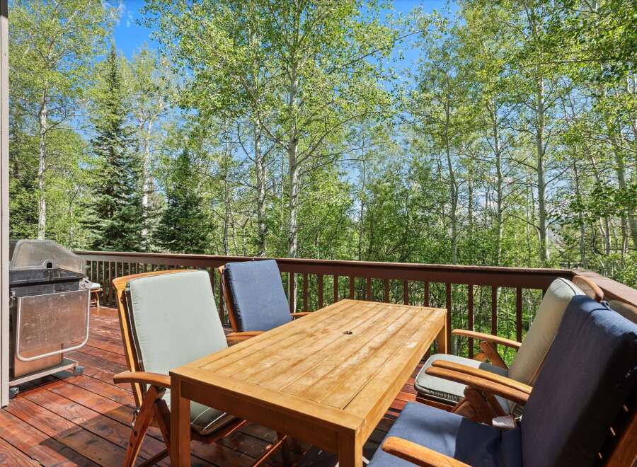 Enjoy outdoor dining and grilling on this spacious deck surrounded by beautiful aspen trees.