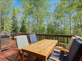 Enjoy outdoor dining and grilling on this spacious deck surrounded by beautiful aspen trees.