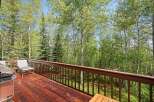 Enjoy the serene mountain views from this spacious deck, perfect for outdoor entertaining or quiet relaxation.